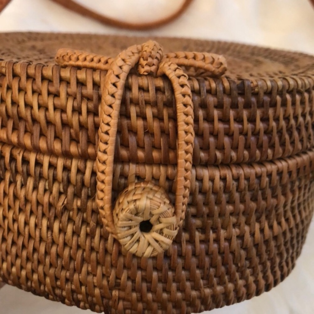 Brand new-Round rattan purse with leather strap.